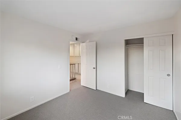 a view of an empty room and closet area