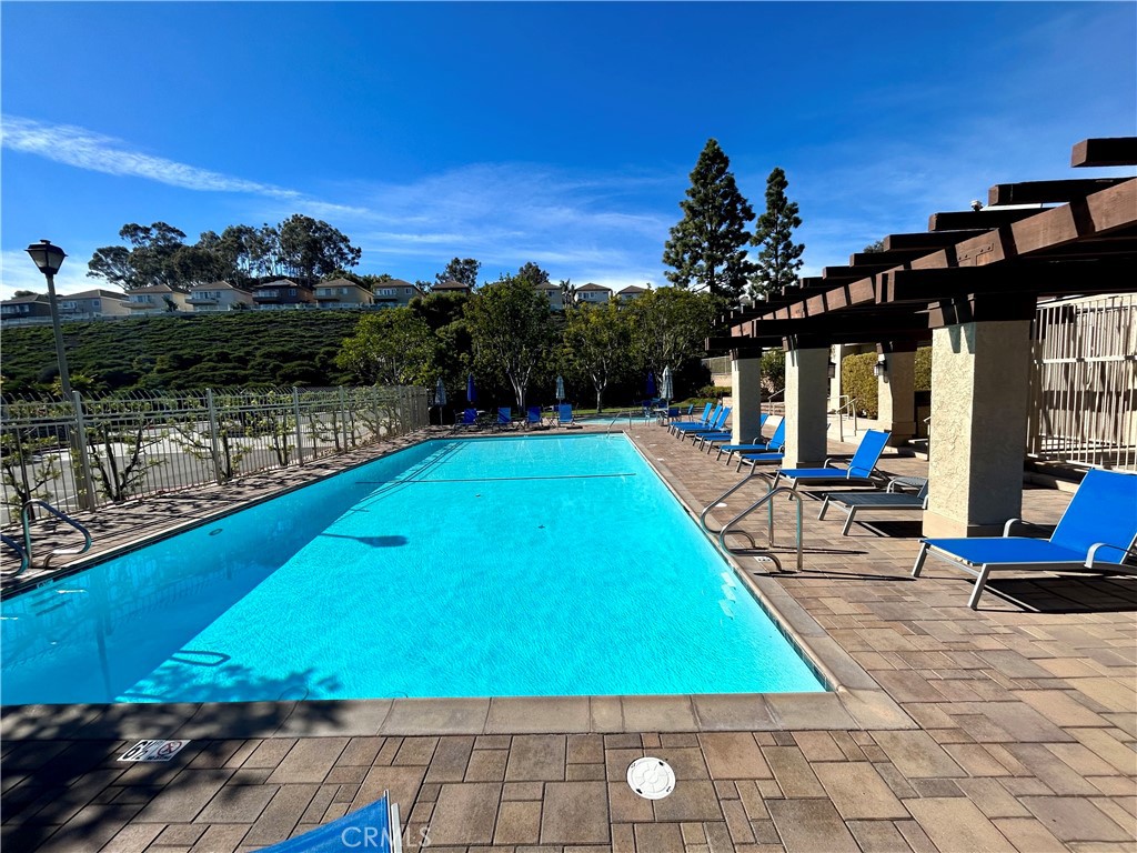 33666 Surfside Drive, Unit 38 Dana Point, CA 92629 - Photo 35 of 39 a view of a swimming pool with a patio and a yard