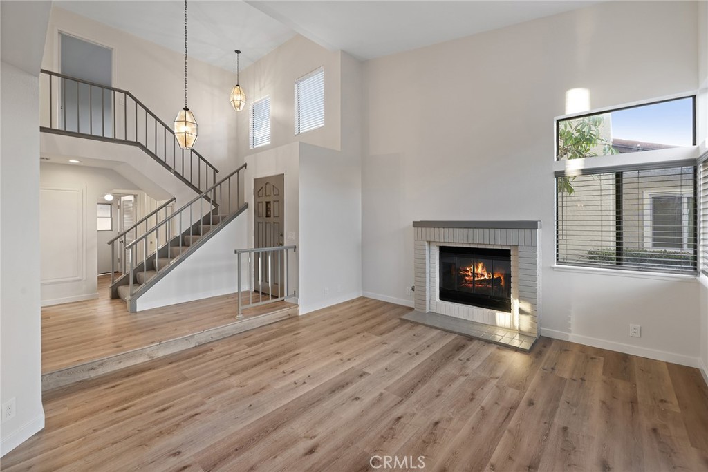33666 Surfside Drive, Unit 38 Dana Point, CA 92629 - Photo 4 of 39 a view of empty room with wooden floor and fireplace