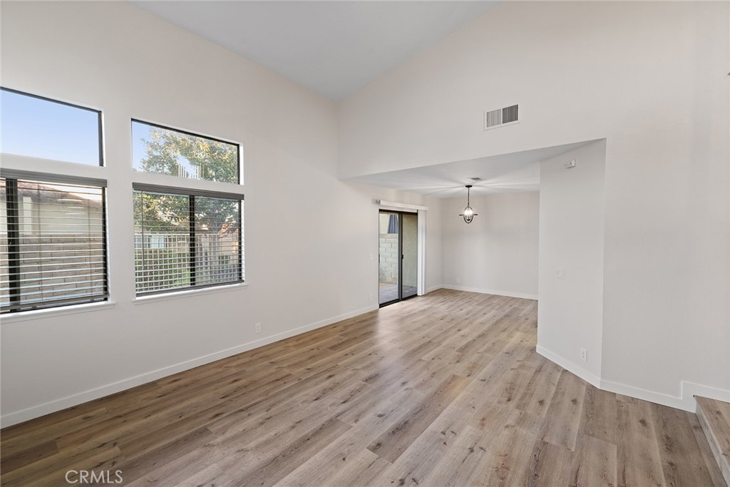 33666 Surfside Drive, Unit 38 Dana Point, CA 92629 - Photo 6 of 39 a view of an empty room with wooden floor and a window