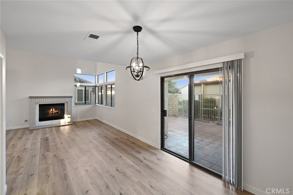33666 Surfside Drive, Unit 38 Dana Point, CA 92629 - Photo 8 of 39 a view of empty room with wooden floor and fireplace