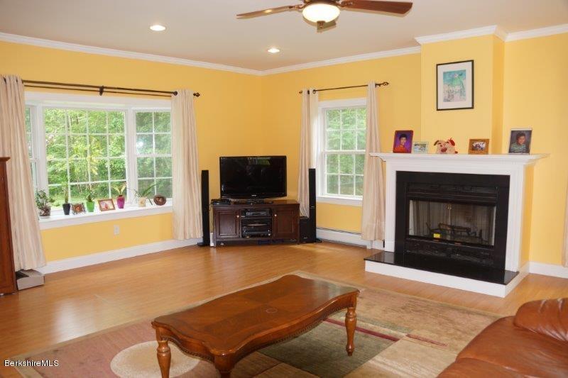 708 Clayton Road Sheffield, MA 01222 - Photo 5 of 19 a living room with furniture a flat screen tv and a fireplace