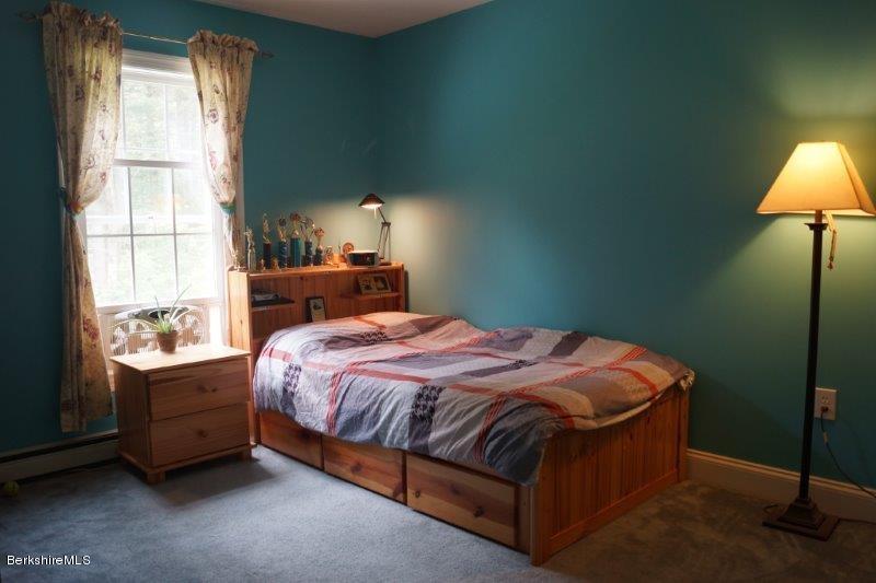 708 Clayton Road Sheffield, MA 01222 - Photo 8 of 19 a bed sitting in a bedroom next to a window