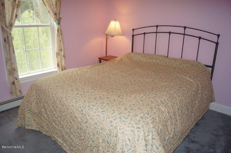708 Clayton Road Sheffield, MA 01222 - Photo 9 of 19 a large bed sitting in a bedroom next to a window