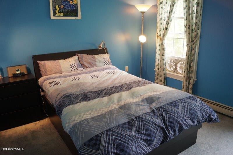708 Clayton Road Sheffield, MA 01222 - Photo 10 of 19 a bed sitting in a bedroom next to a window
