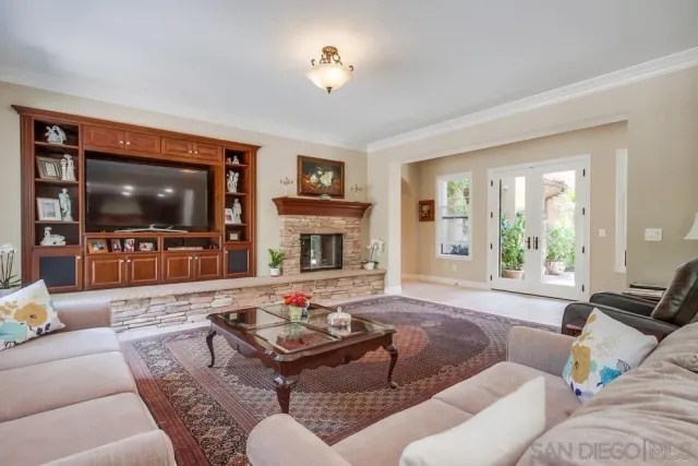 a living room with furniture flat screen tv and a large window
