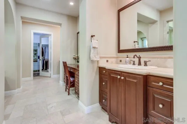 a en suite bathroom with a double vanity sink and a mirror