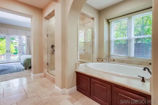 a spacious bathroom with sink shower and bathtub