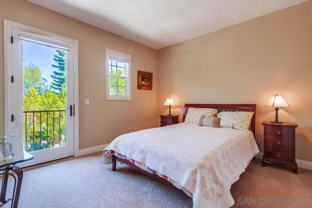 a bedroom with a bed lamp and window