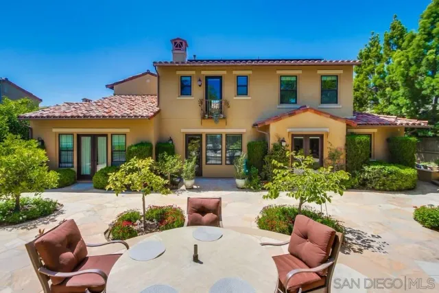 a front view of a house with a porch and furniture
