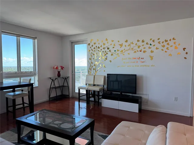 a living room with furniture a table and a flat screen tv