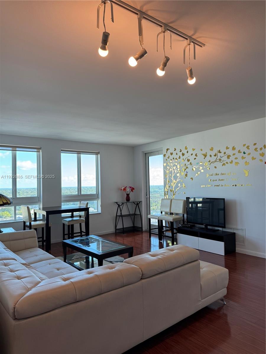7350 Southwest 89th Street, Unit 1801S Miami, FL 33156 - Photo 14 of 15 a living room with furniture and wooden floor