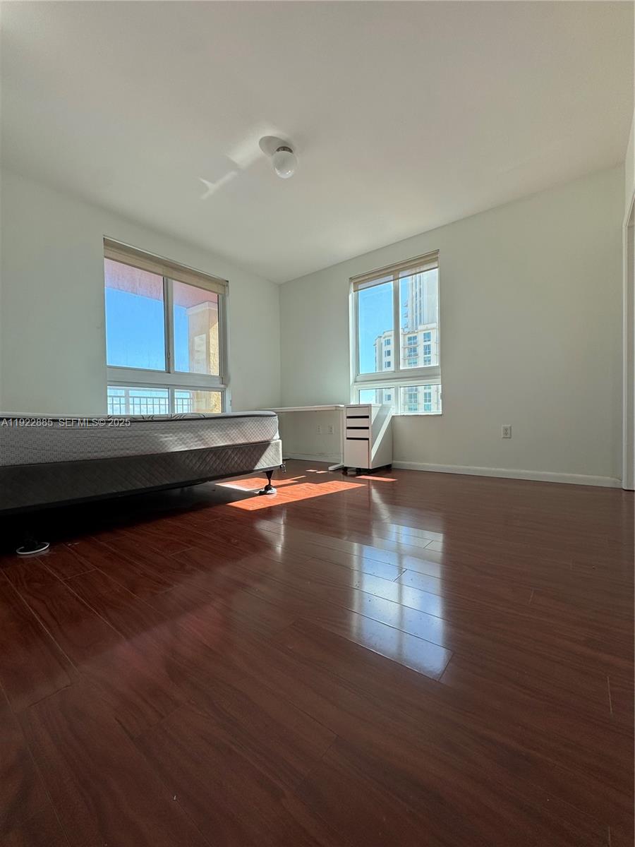 7350 Southwest 89th Street, Unit 1801S Miami, FL 33156 - Photo 9 of 15 a view of empty room with wooden floor and fan