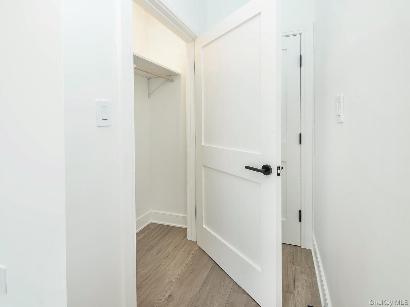 24 Lumber Road, Unit 1 Roslyn, NY 11576 - Photo 12 of 18 a view of a hallway with wooden floor