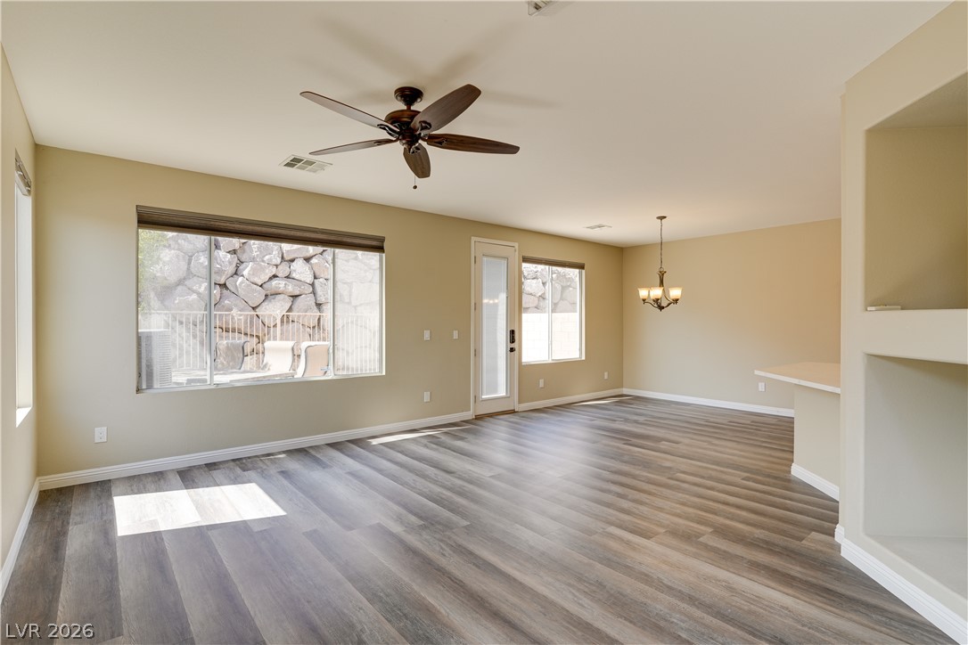 703 Principle Point Avenue Henderson, NV 89012 - Photo 5 of 29 A spacious room offers comfortable living with modern flooring and abundant natural light.