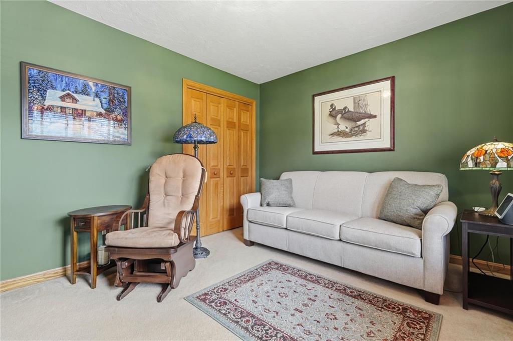 103 Seminole Trail Butler, PA 16001 - Photo 15 of 50 a living room with furniture a rug and a wall painting