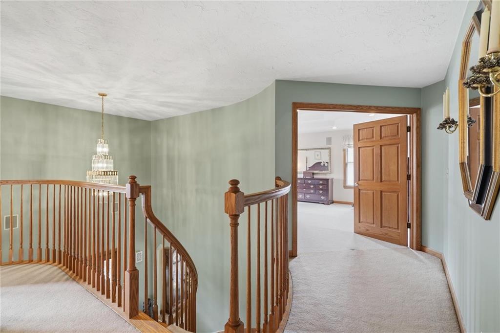 103 Seminole Trail Butler, PA 16001 - Photo 17 of 50 a view of a hallway with wooden floor and windows