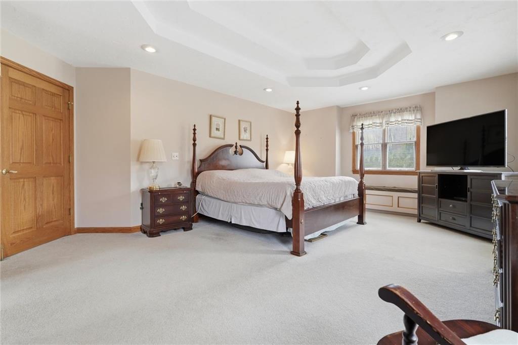 103 Seminole Trail Butler, PA 16001 - Photo 18 of 50 a spacious bedroom with a bed and a flat screen tv