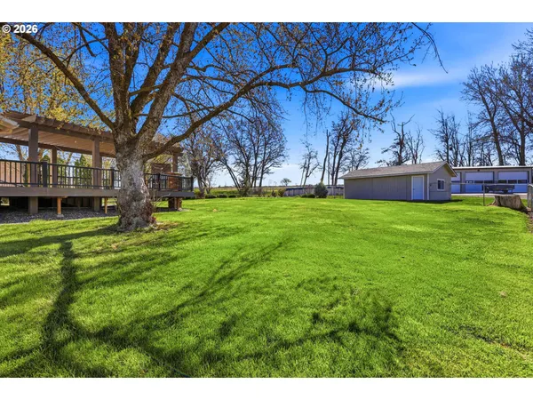 a backyard of a house with table and chairs