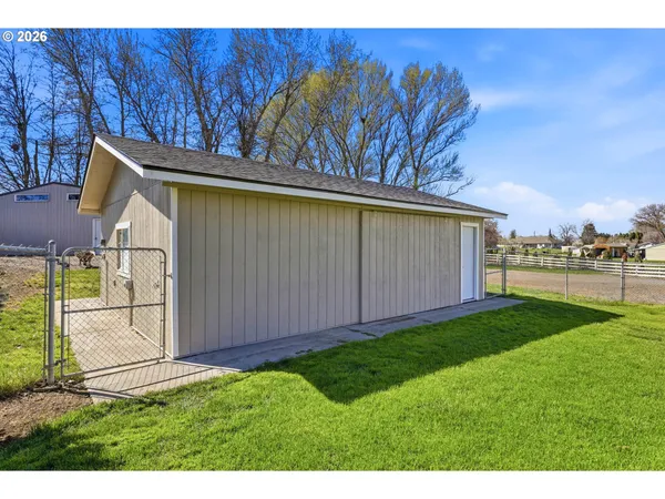 a view of a backyard with large trees