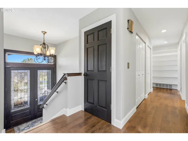 a view of a kitchen with furniture and wooden floor