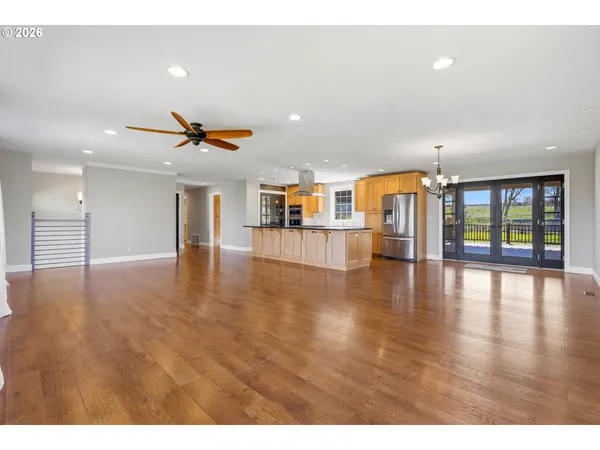 a kitchen with stainless steel appliances granite countertop a refrigerator a sink and a stove