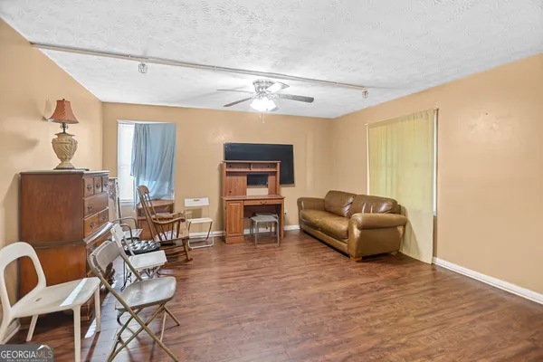 a view of a workspace with furniture and a window