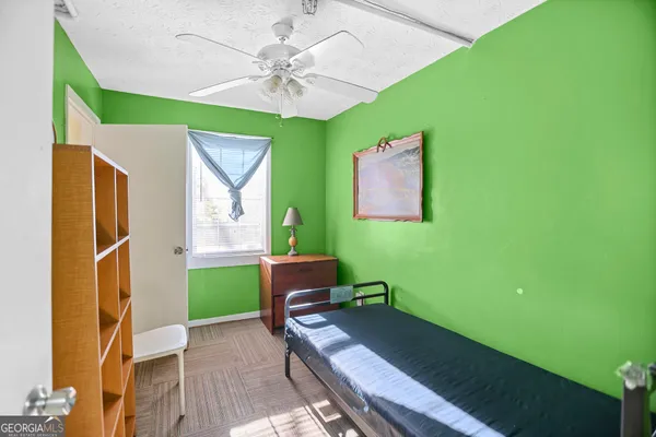 a view of a hallway with closet and window