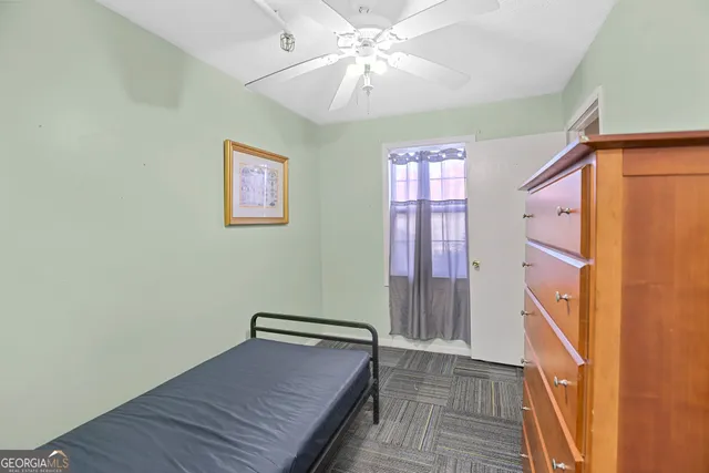 a view of a hallway with wooden floor and closet
