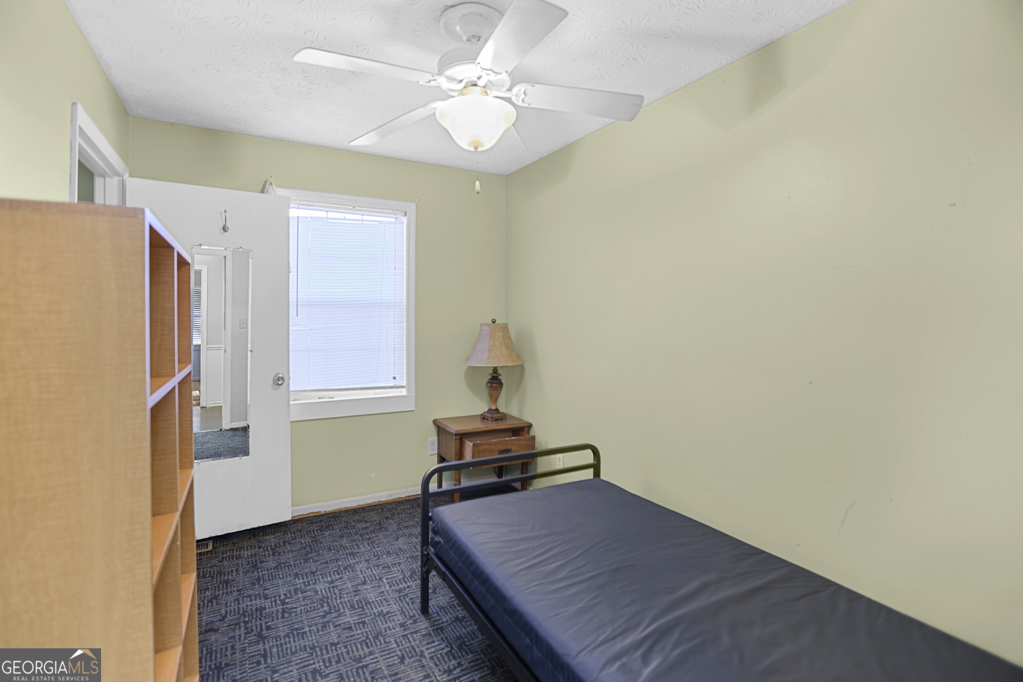 492 Pine Road Newnan, GA 30263 - Photo 25 of 36 a bedroom with a bed and a chandelier