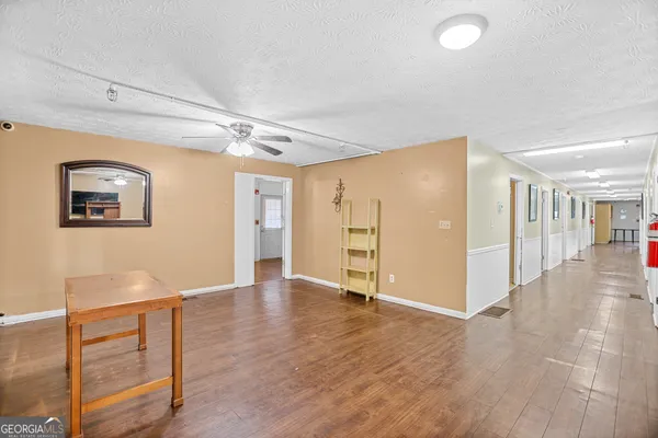 a view of an empty room with wooden floor