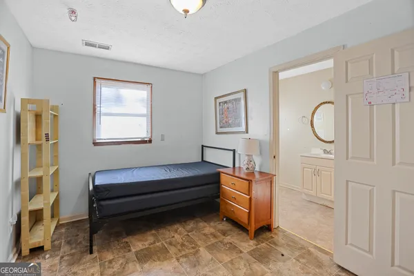 a living room with furniture a baby crib and a window