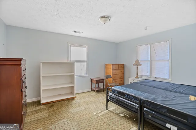 a bedroom with a bed and a cabinets