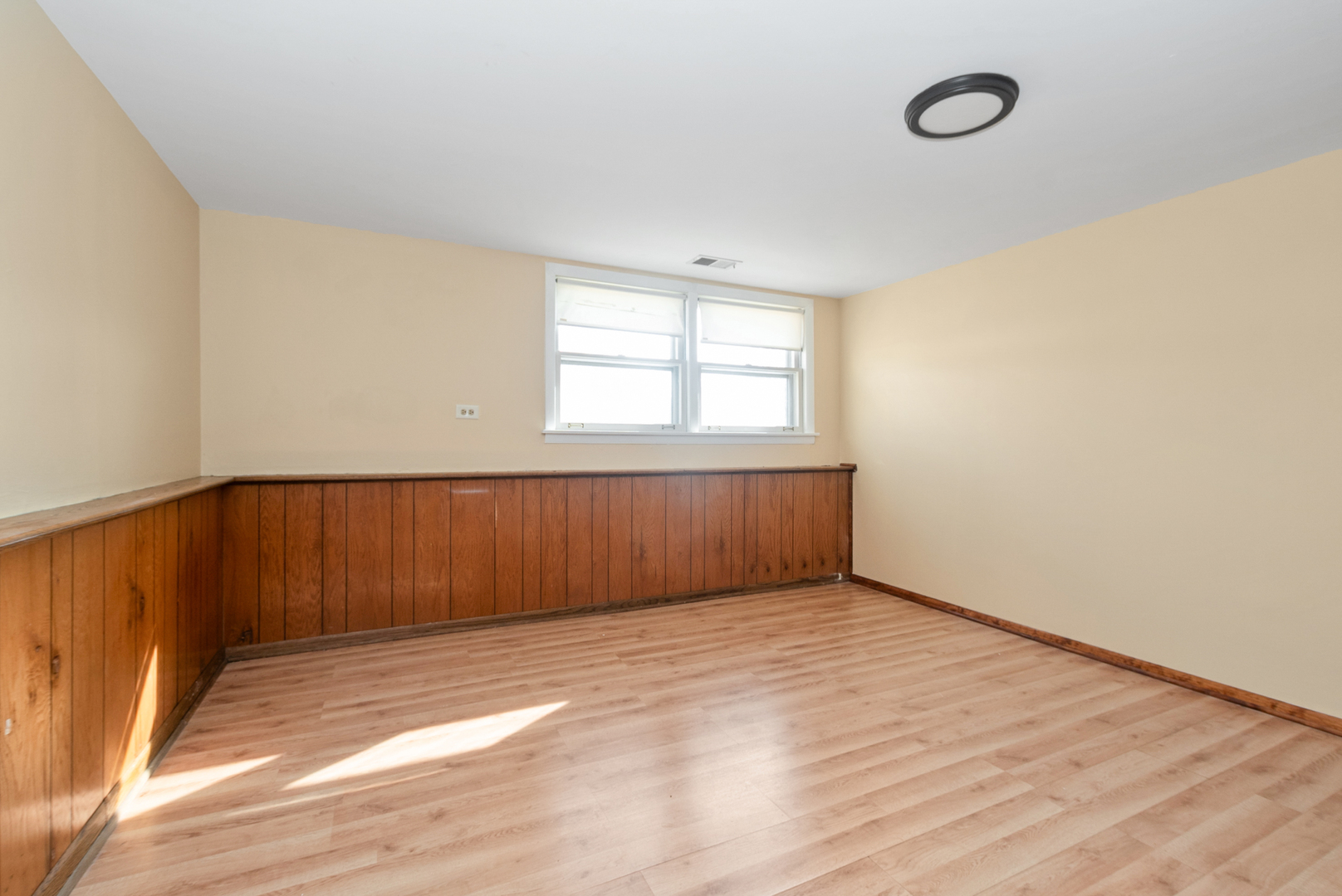4937 West 85th Place Burbank, IL 60459 - Photo 21 of 32 an empty room with wooden floor and windows