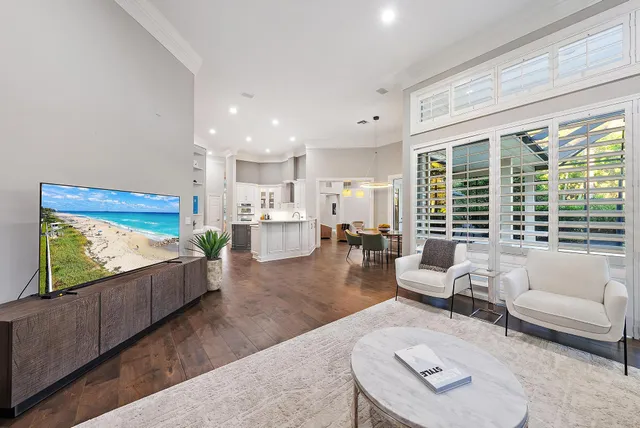 a living room with furniture potted plant and a window