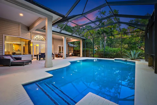 a view of a patio with table and chairs under an umbrella