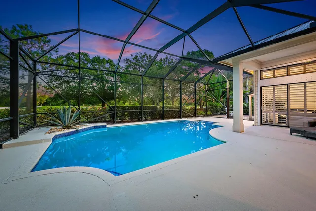 a view of a patio with a table and chairs under an umbrella