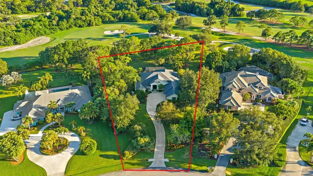 an aerial view of a house with a yard and swimming pool