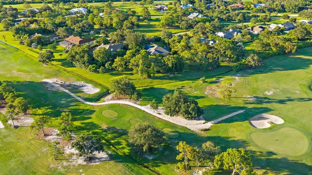 an aerial view of a house with a swimming pool yard and outdoor seating