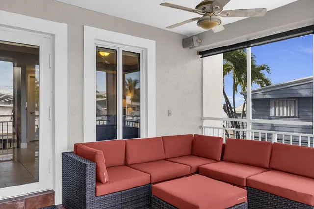 a living room with furniture a ceiling fan and a window