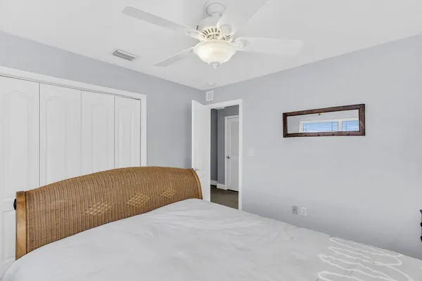a bedroom with a bed and a ceiling fan
