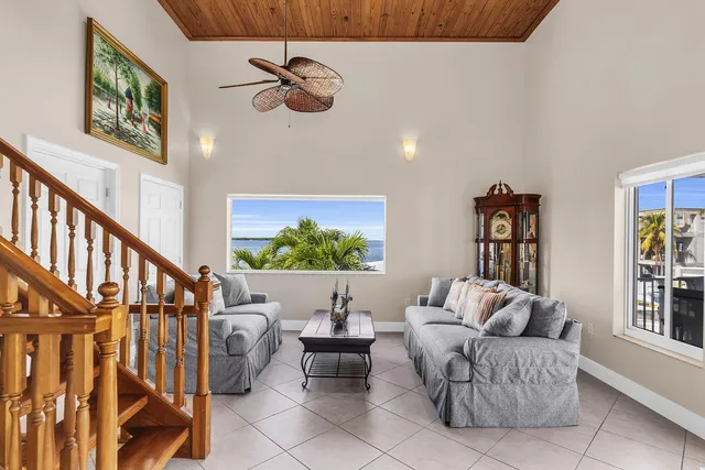 a living room with furniture ceiling fan and a rug
