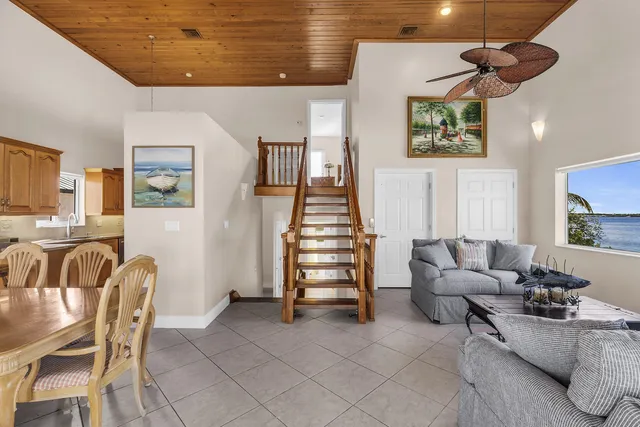 a living room with furniture and stairs