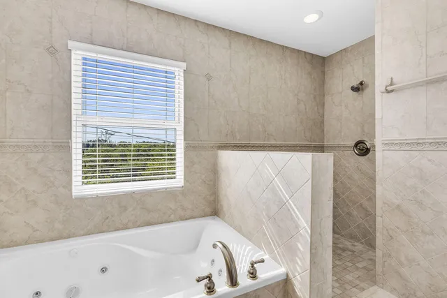 a white bath tub sitting next to a window