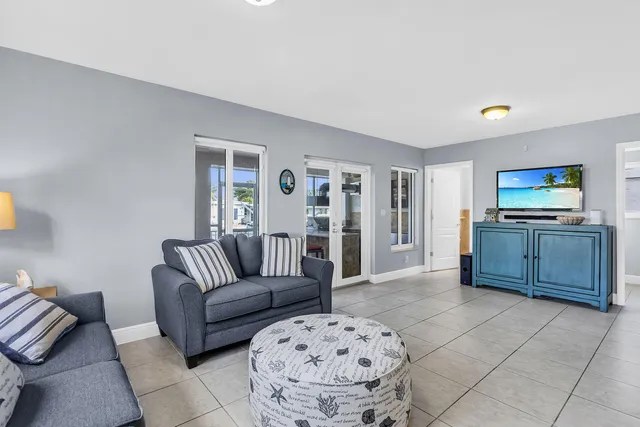 a living room with furniture and kitchen view