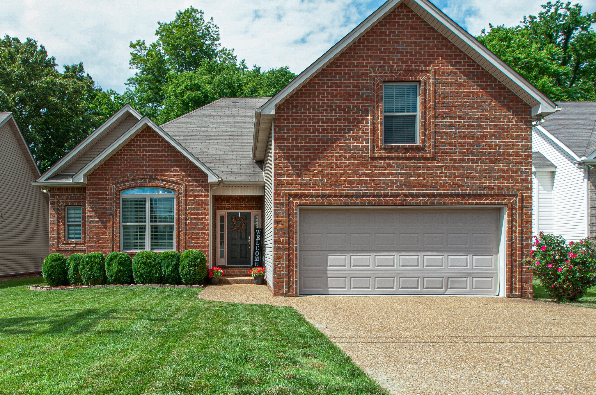 1068 Golf View Way Spring Hill, TN 37174 - Photo 3 of 40 a front view of a house with a yard and garage