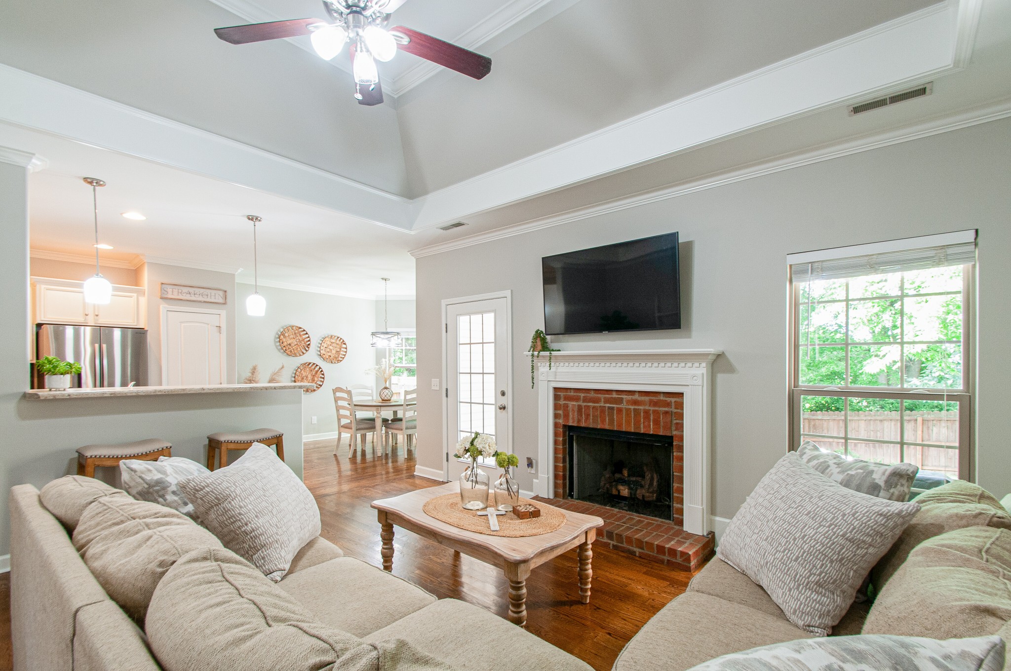 1068 Golf View Way Spring Hill, TN 37174 - Photo 8 of 40 a living room with furniture a flat screen tv and a fireplace