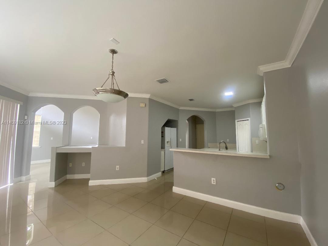 5586 Northwest 112th Path Doral, FL 33178 - Photo 11 of 30 a view of a room with wooden floor and windows