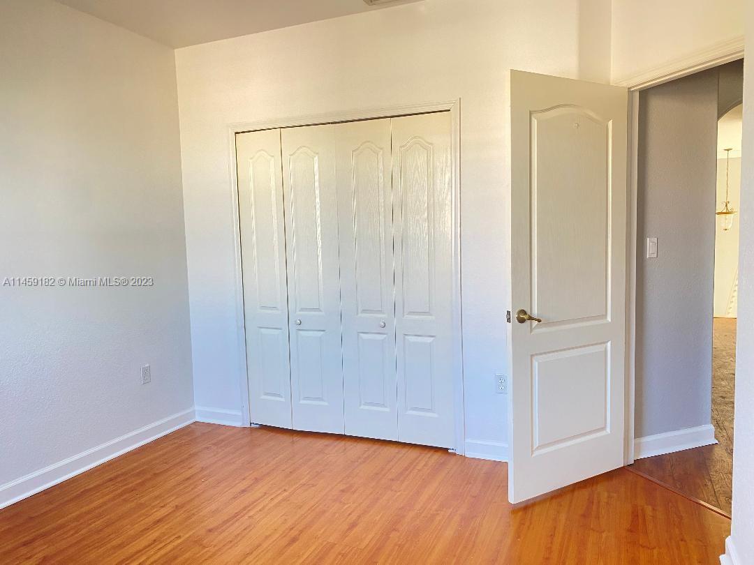 5586 Northwest 112th Path Doral, FL 33178 - Photo 18 of 30 a view of an empty room with wooden floor