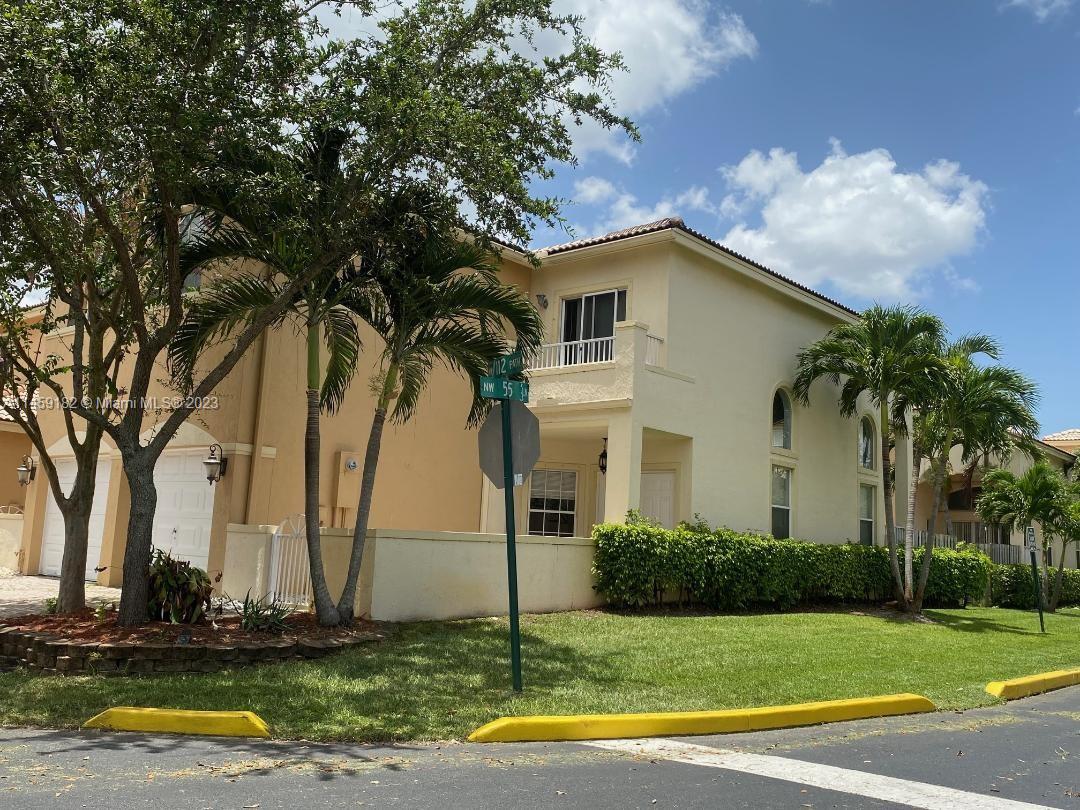 5586 Northwest 112th Path Doral, FL 33178 - Photo 26 of 30 a white house that has a tree in front of it